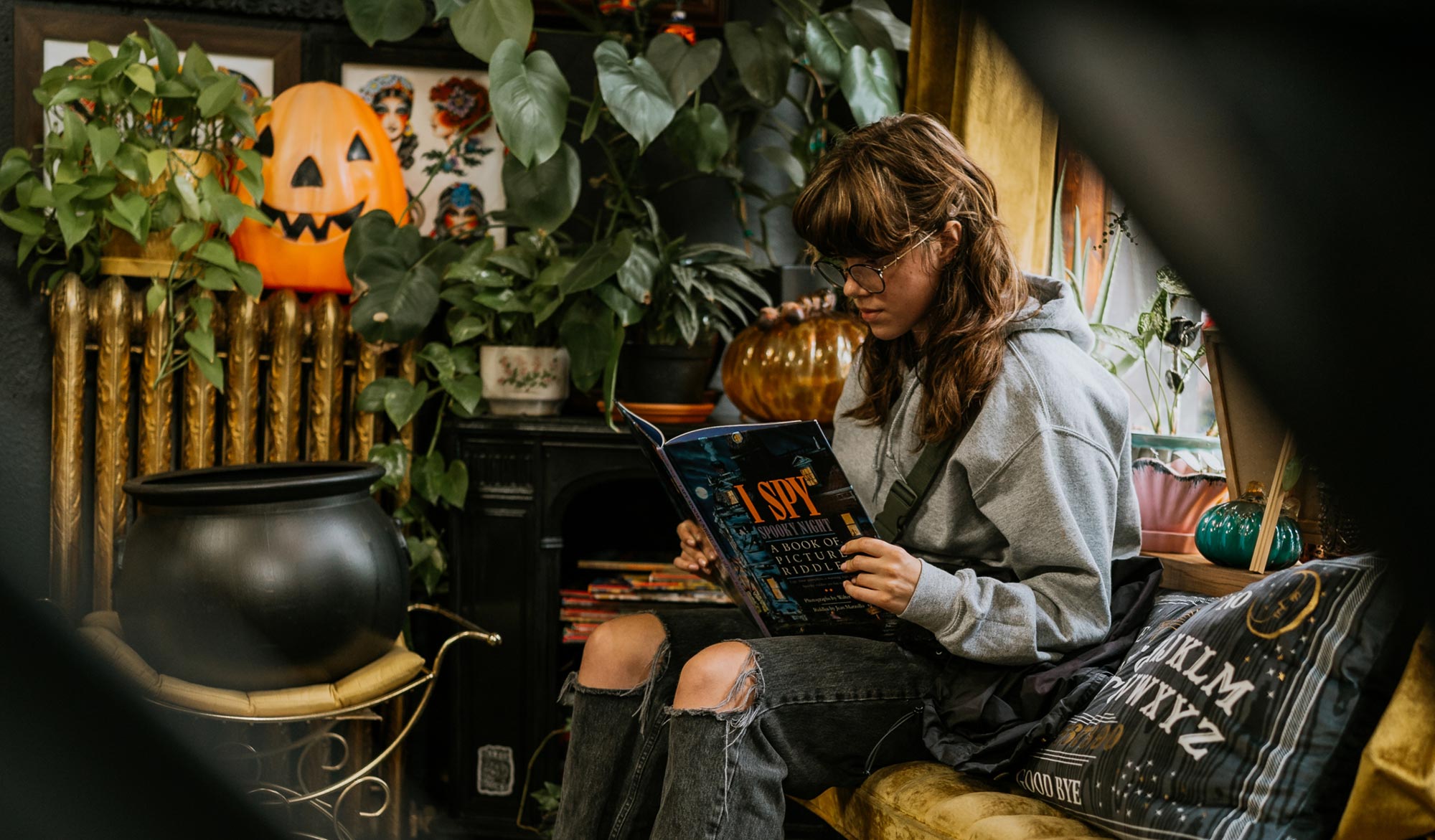 Women reading an ISPY book in the Black Magic Tattoo waiting room.